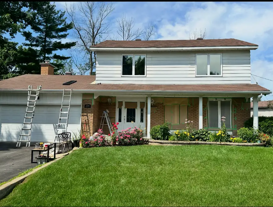 Two-storey Montreal house — siding masked and prepped before spraying
