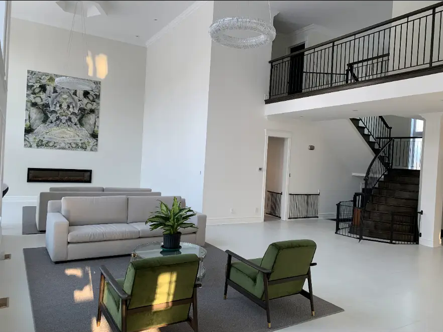 Interior painting project — finished bright white living room after